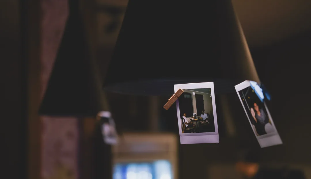 Polaroid photographs of guests pegged up above the bar at Amigo