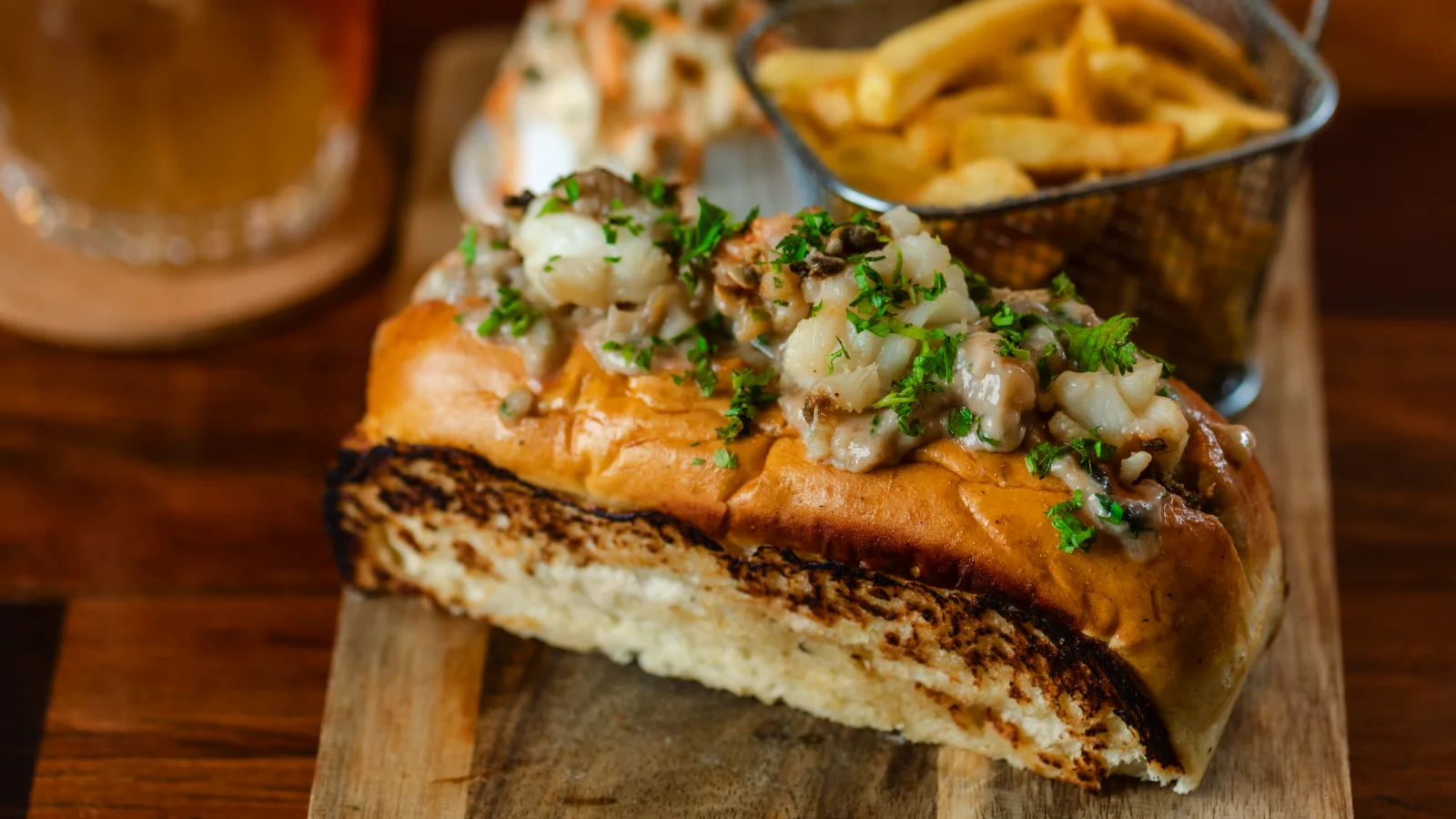Amigo Bar & Bistro lobster roll: brioche bun, chilled lobster salad, fries and house slaw