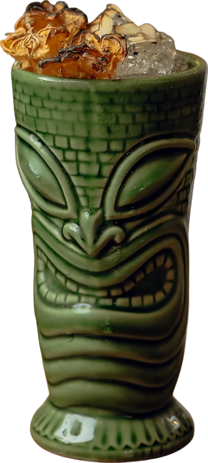 The Tiki Tiki in a carved green tiki mug, topped with dried pineapple
